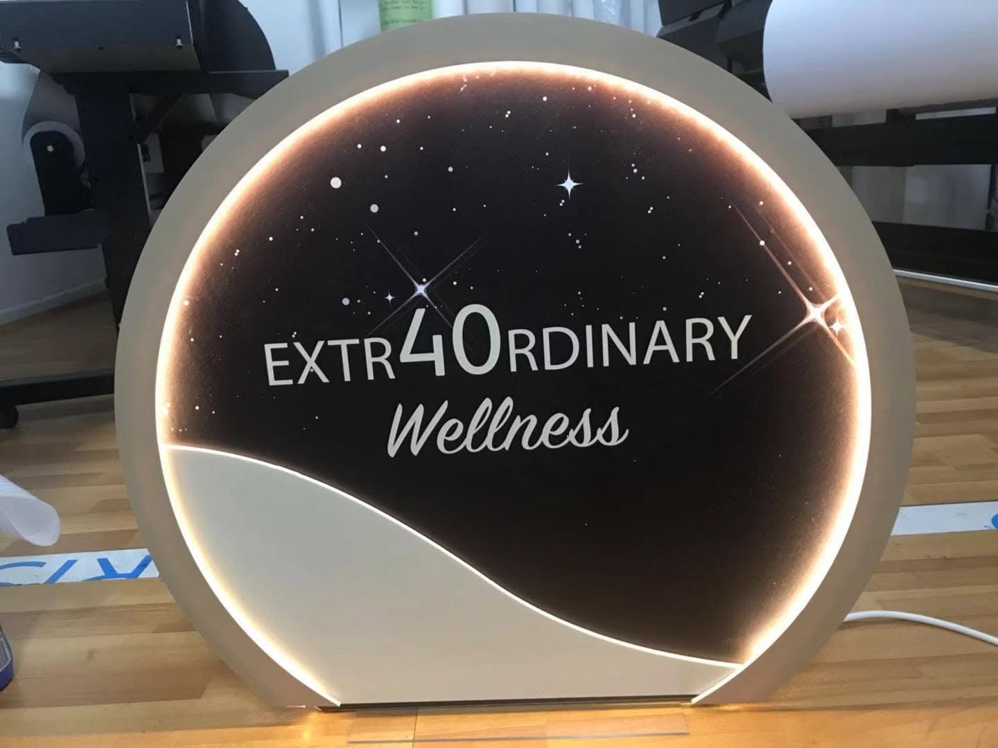 Circular illuminated display for Extraordinary Wellness in the workshop