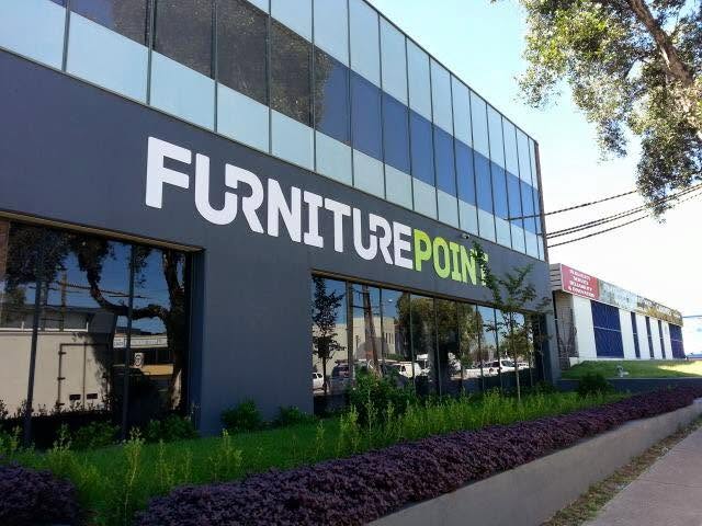 Building fascia letters across a two-storey showroom frontage
