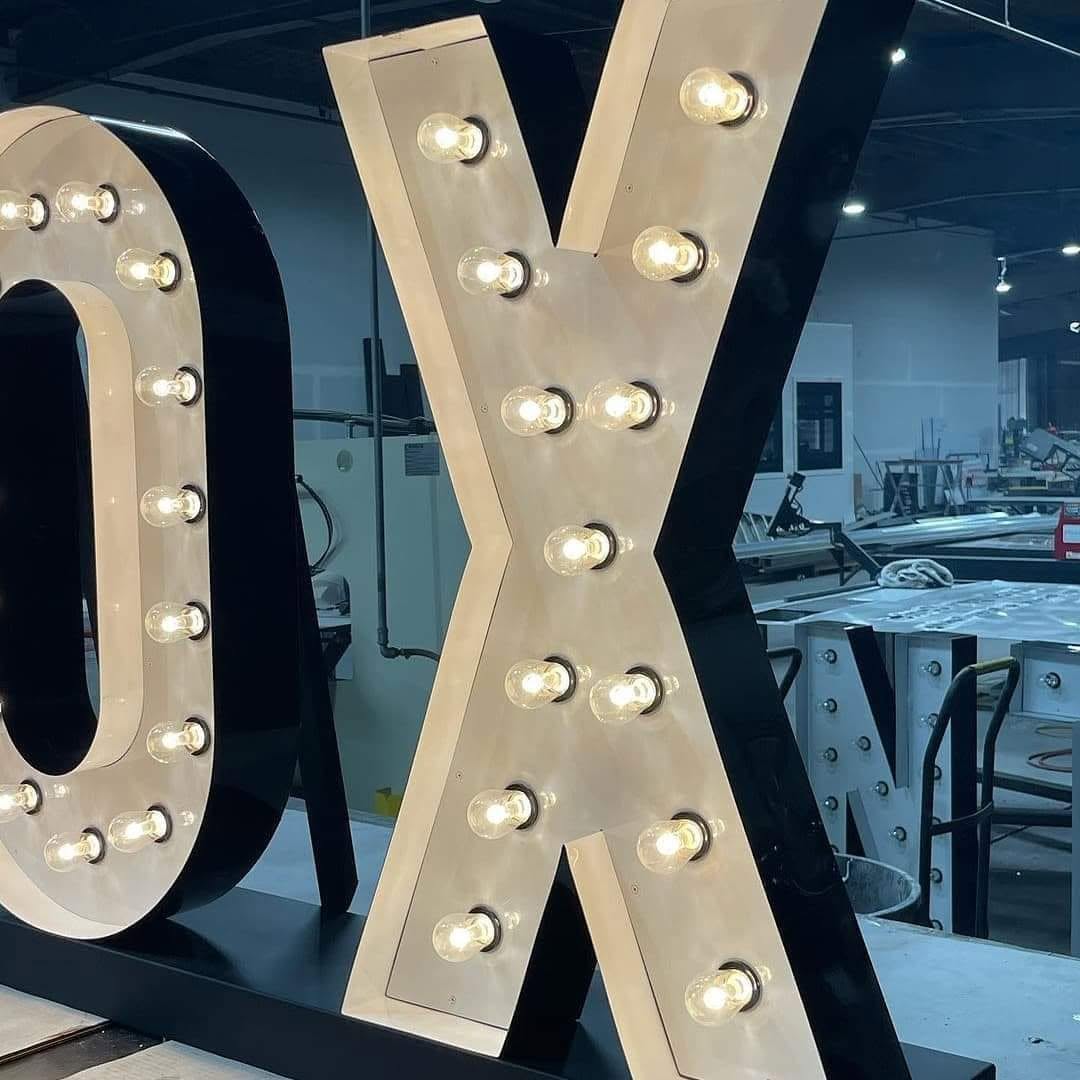 Marquee letters with welded steel standing bases in the workshop