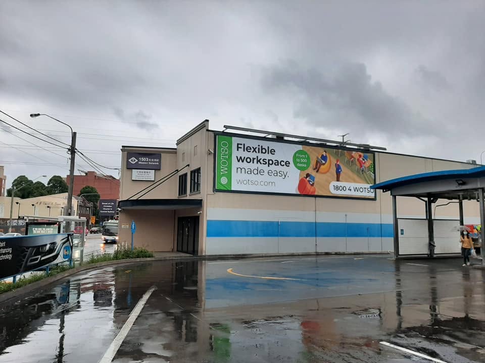 Large-format WOTSO banner installed high on a building